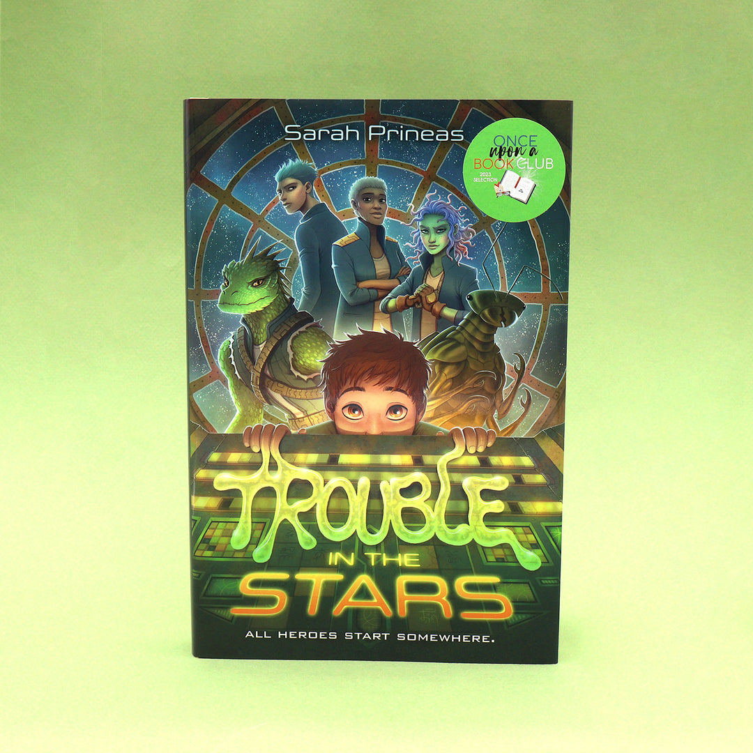 Book titled 'Trouble in the Stars' by Sarah Prineas on a green background