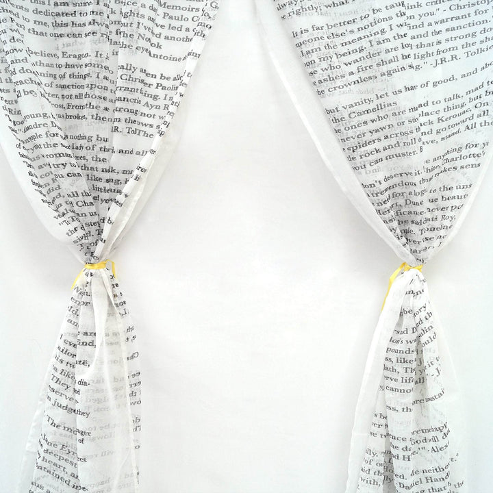 white curtains with book quotes in black writing across them