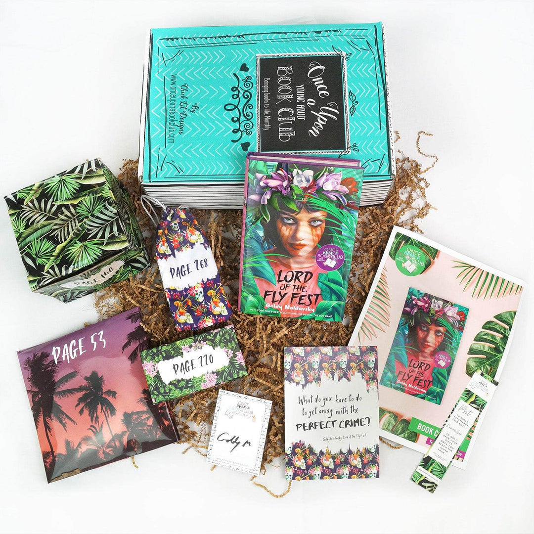 A hardcover edition of Lord of the Fly Fest leans against a green Once Upon a Book Club box. In front are two green boxes, pink folder, drawstring bag, signature card, quote card, bookclub kit, and bookmark. All boxes and bags are labeled with page numbers.