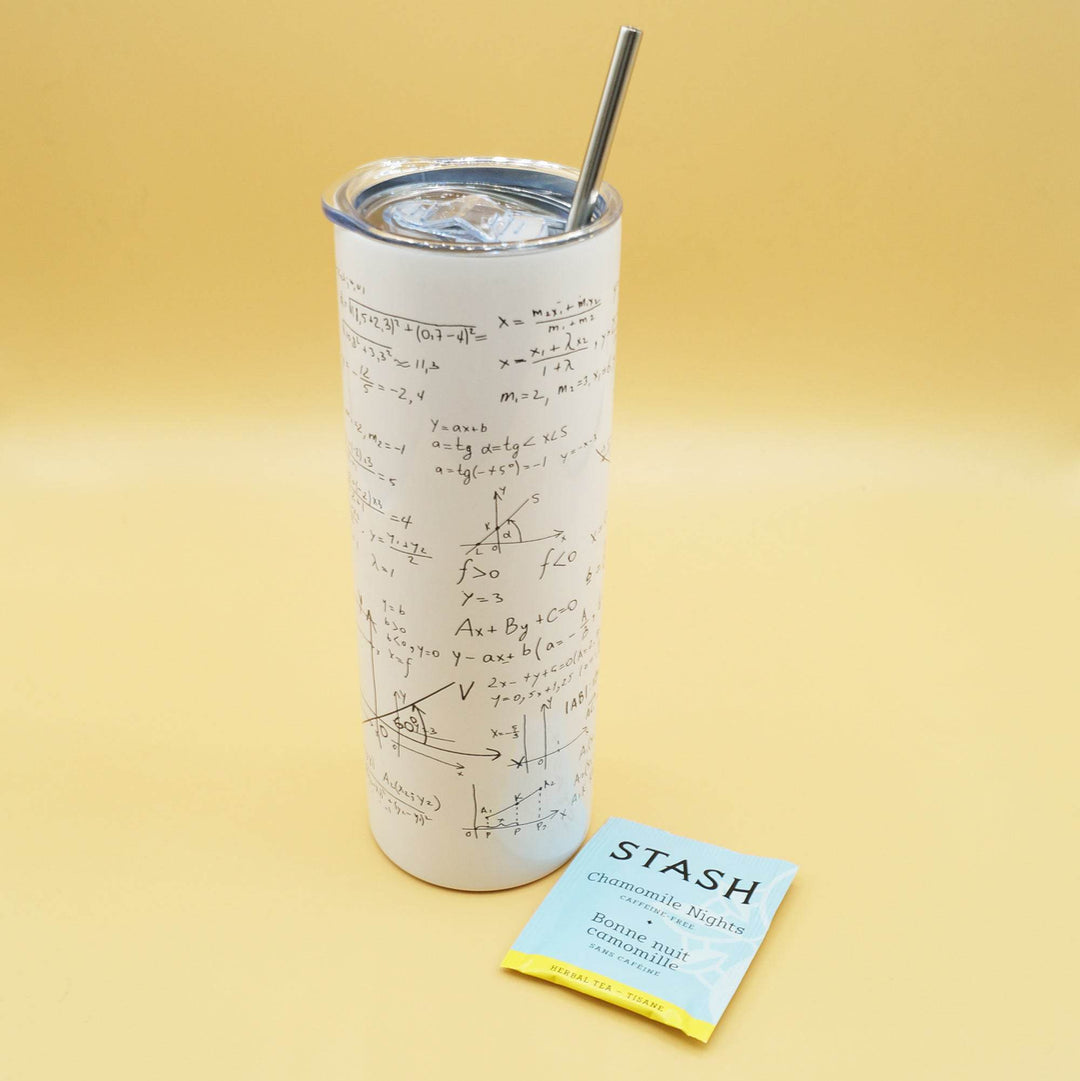 a white tumbler with black equations across it and a metal straw coming out of the top is next to a packet of Stash tea